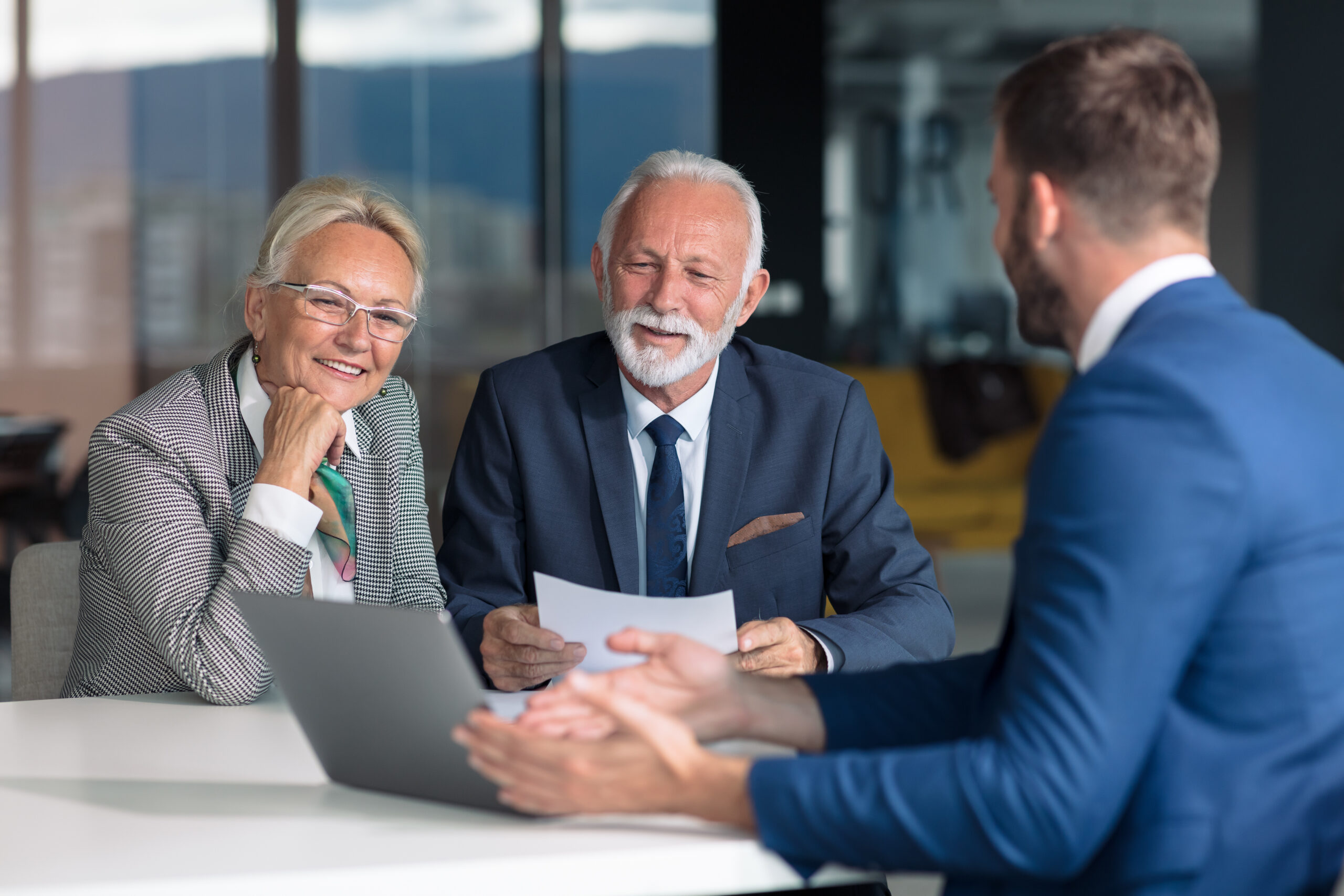 man-in-insurance-industry-working-with-clients-at-desk