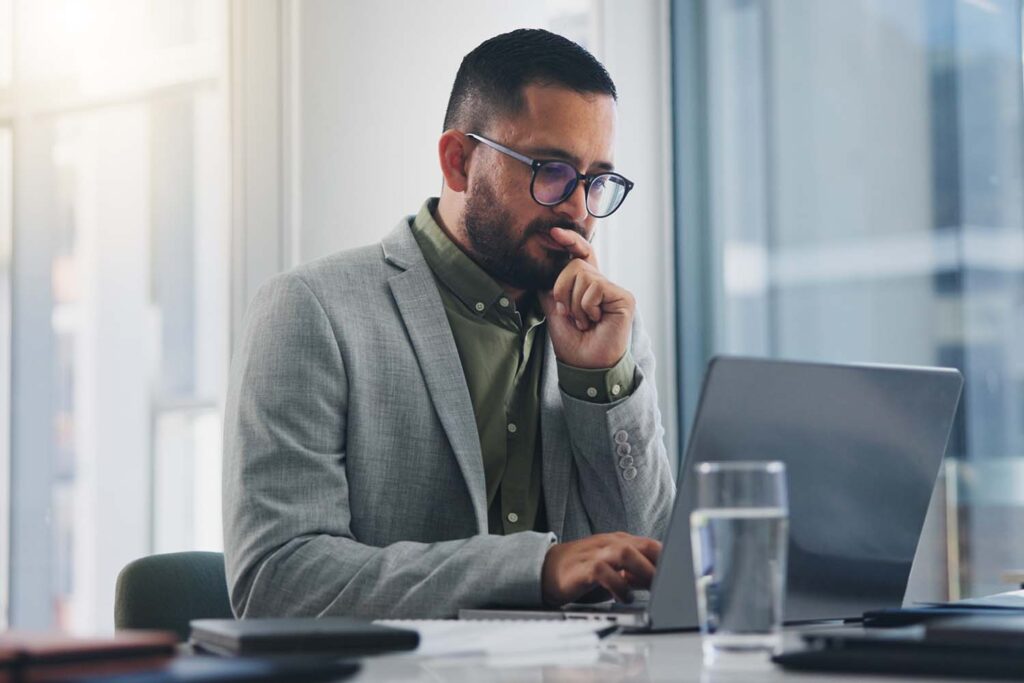 man-at-desk-looking-at-laptop