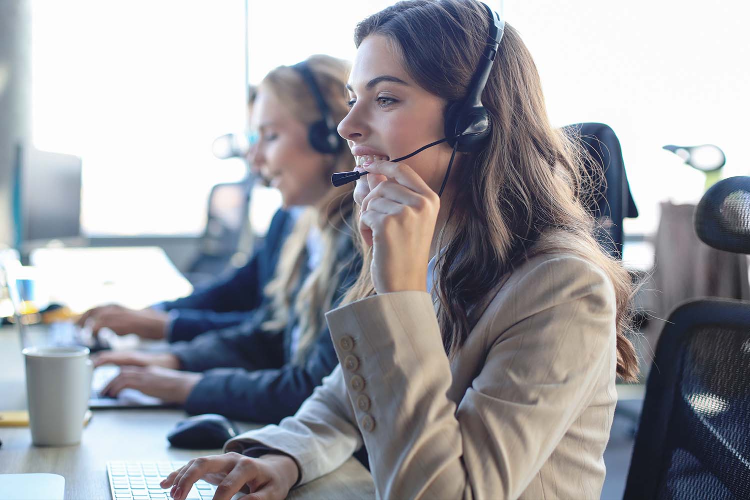 woman-with-headset-at-desk